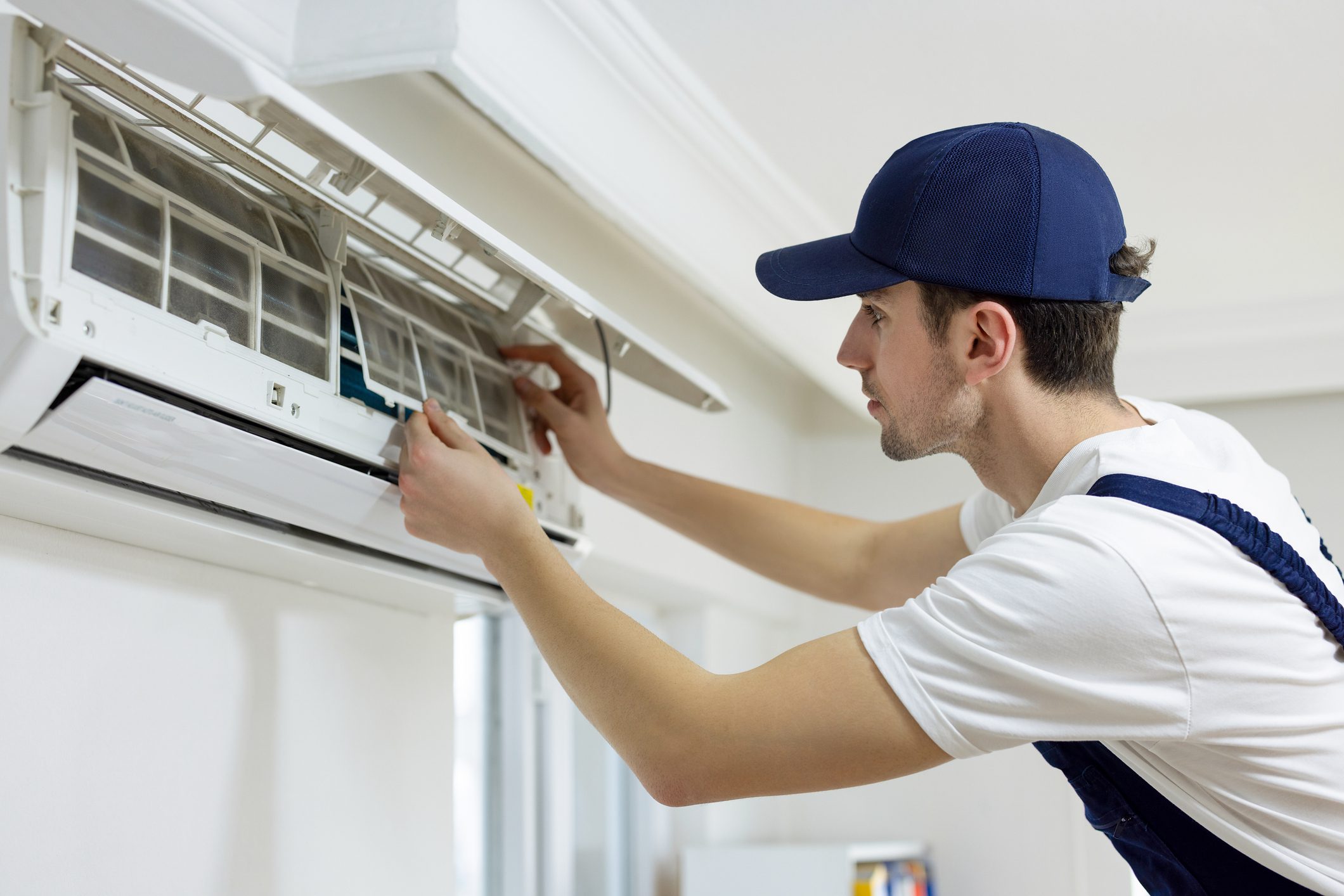 Technician repairing an air conditioning unit.