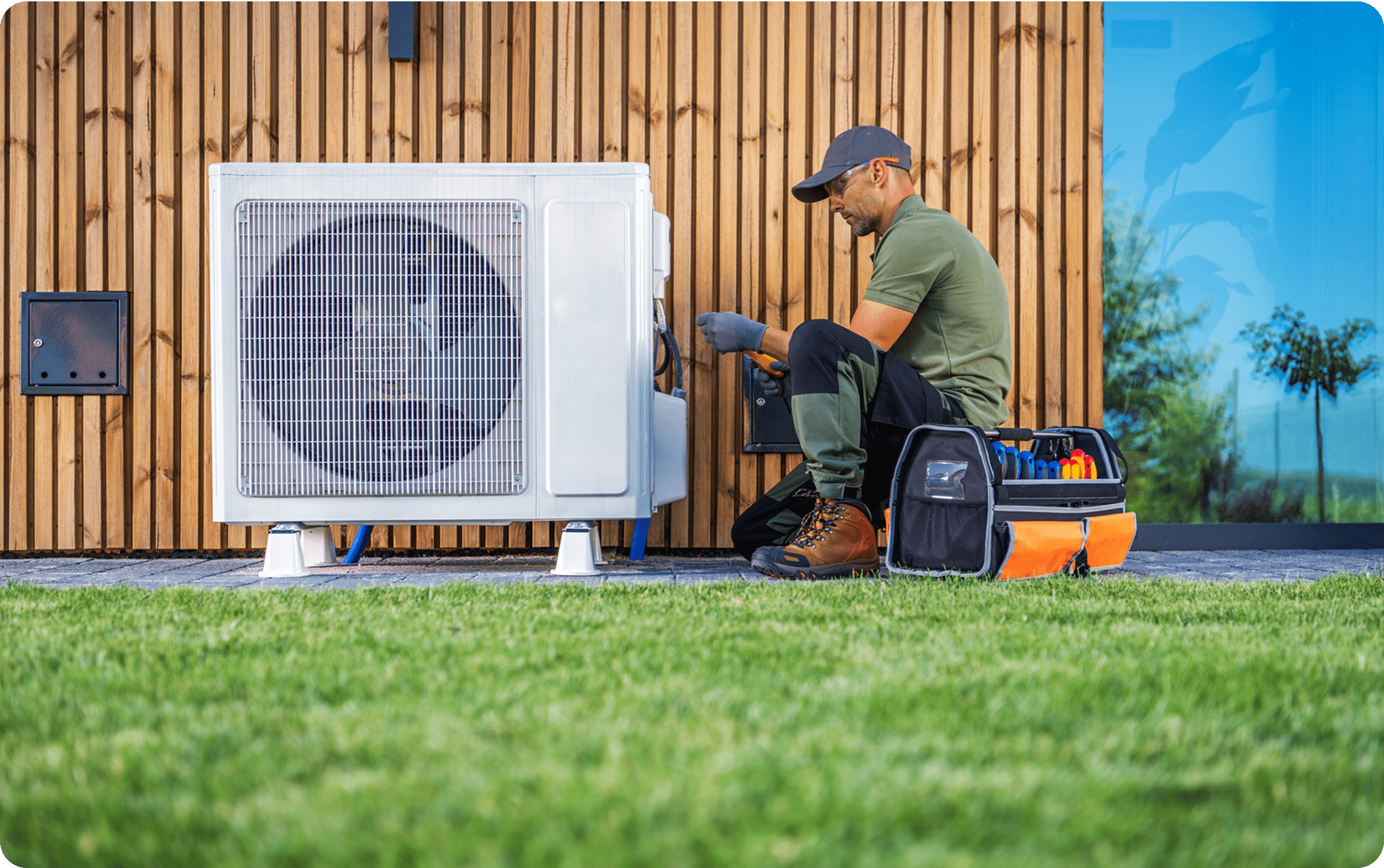 Technician repairing outdoor air conditioning unit.